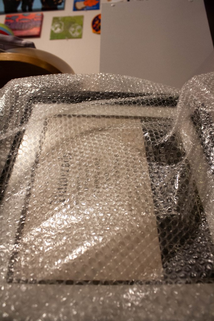 A close-up image of a diploma frame wrapped in bubble wrap